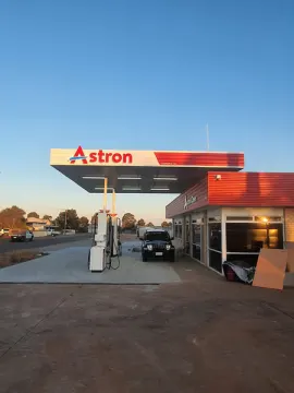 Gas station with car parked in front at Astron Service Station for sale in Cleve.