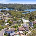 An aerial perspective of a residential neighborhood nestled in lush greenery