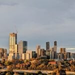 A wide skyline view of a modern city under a clear sky