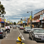 A street-level view of a busy suburban commercial road