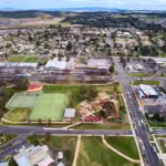 An aerial view of a sprawling suburban town, showing residential houses