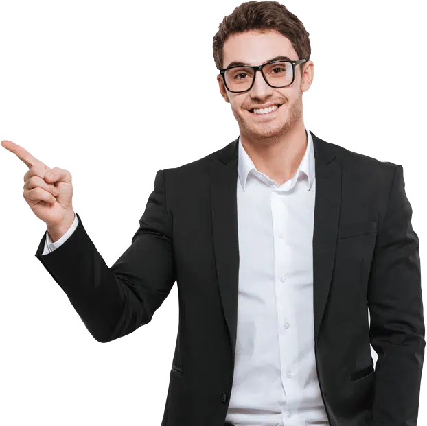 A smiling man in a black suit, white shirt, and glasses pointing his finger toward the left