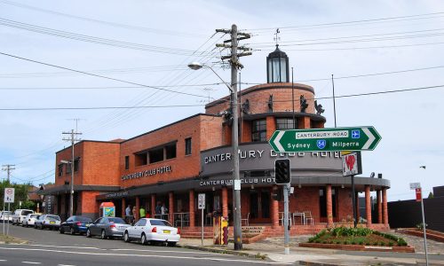 A street-level view of the red brick Canterbury Club Hotel