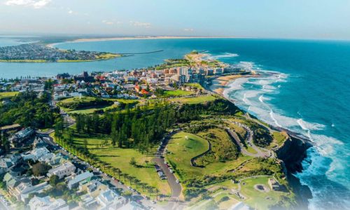 An aerial view of a vibrant coastal city situated on a peninsula
