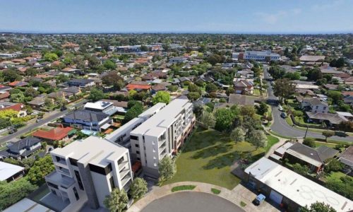An aerial artist's impression of a modern, multi-storey residential building featuring a white facade and balconies