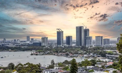 An elevated wide-angle view of a city skyline at sunset