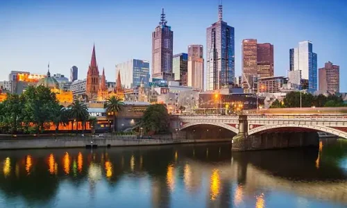 A view of the Melbourne skyline at dusk from across the Yarra River
